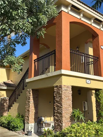 a view of a house with a small yard