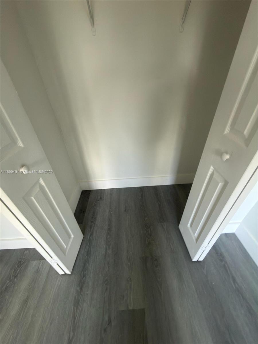 930 Northeast 34th Avenue, Unit 201 Homestead, FL 33033 - Photo 21 of 26 a view of an empty room with wooden floor