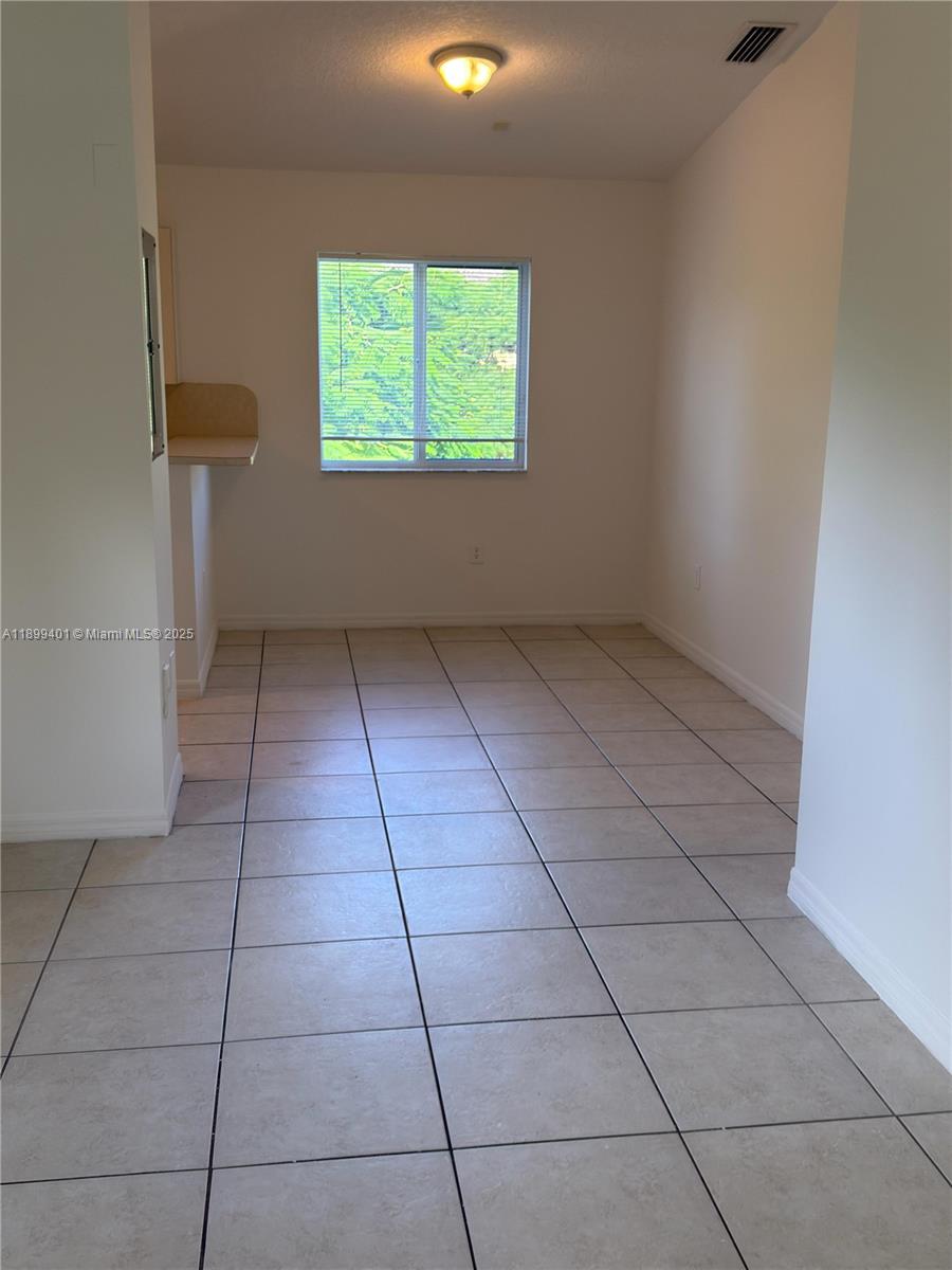 930 Northeast 34th Avenue, Unit 201 Homestead, FL 33033 - Photo 9 of 26 a view of an empty room with a window
