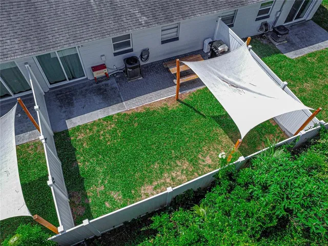 a view of a backyard with sitting area
