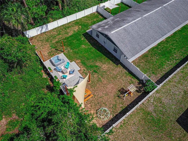 a view of a backyard with sitting area