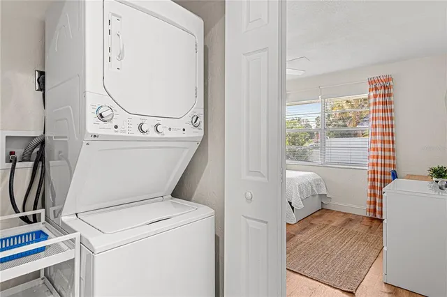a view of washer and dryer with bathroom in the background