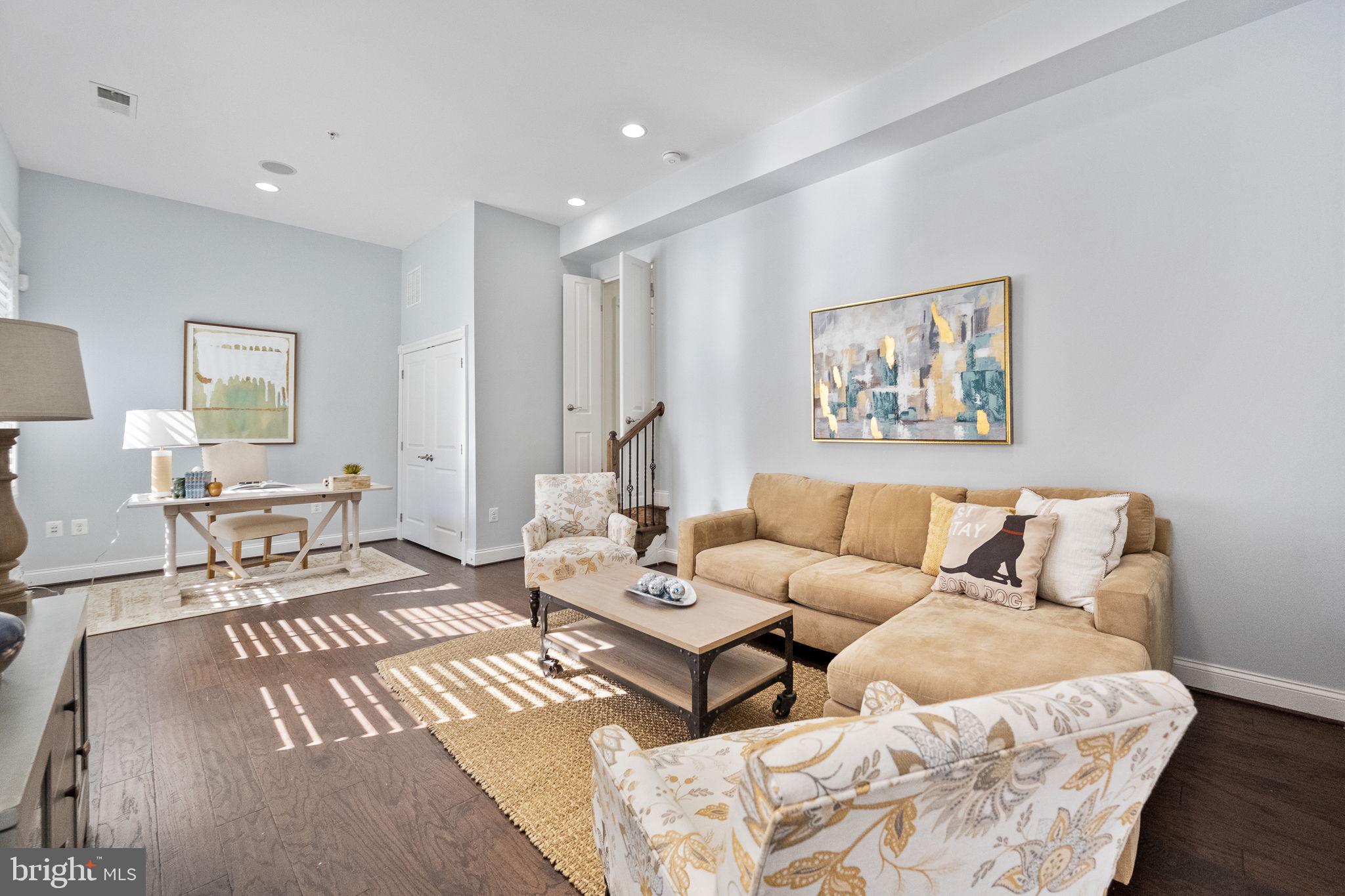 1411 Ridgeview Way Washington, DC 20007 - Photo 11 of 56 a living room with furniture a rug and a painting on the wall