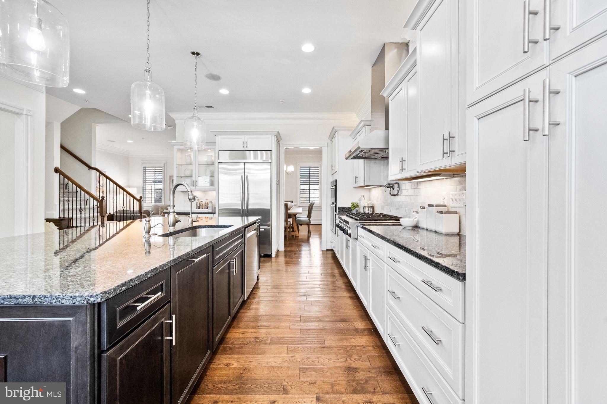 1411 Ridgeview Way Washington, DC 20007 - Photo 17 of 56 a large kitchen with stainless steel appliances kitchen island granite countertop a large counter top
