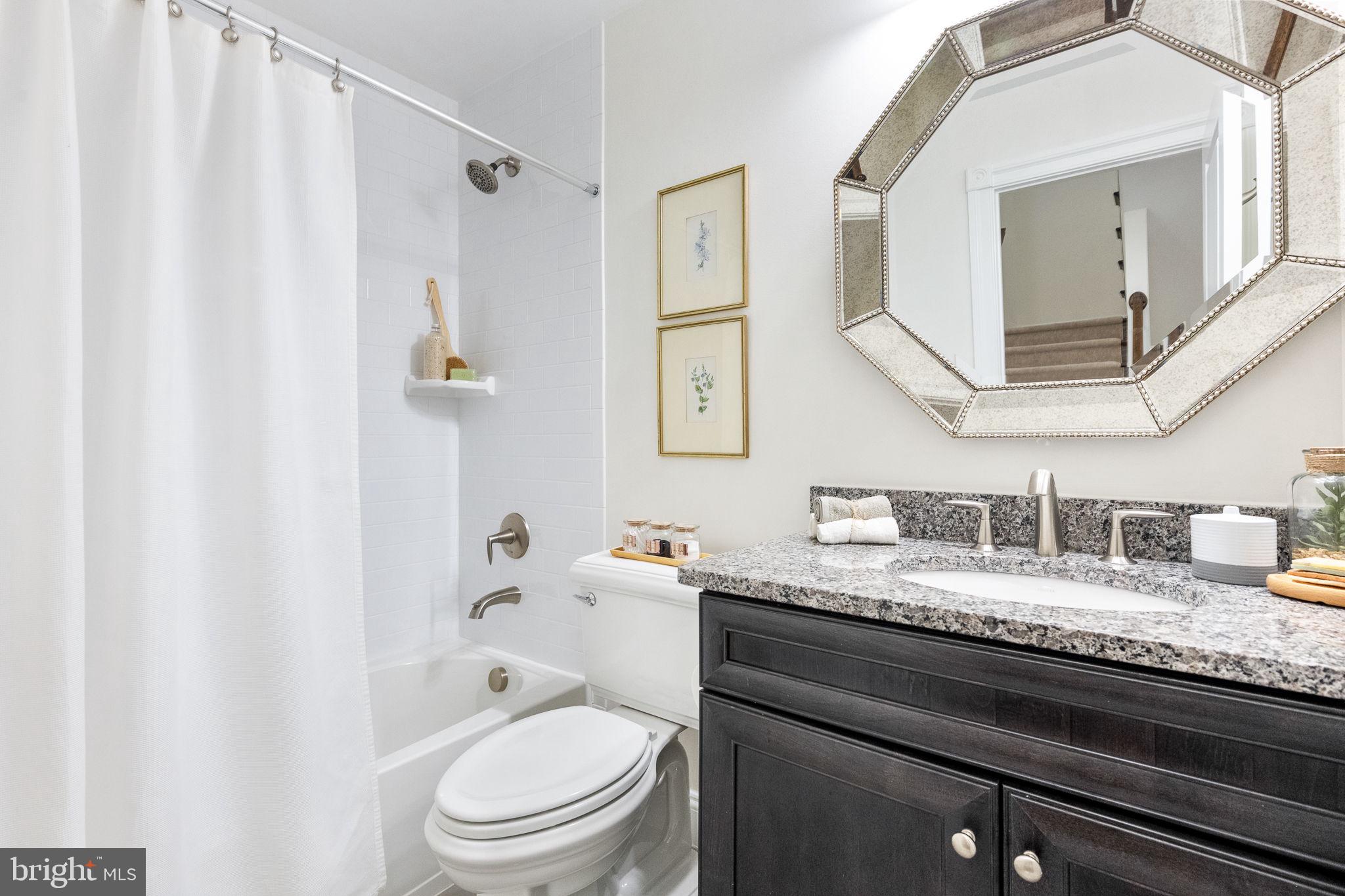 1411 Ridgeview Way Washington, DC 20007 - Photo 32 of 56 a bathroom with a granite countertop sink vanity mirror and toilet