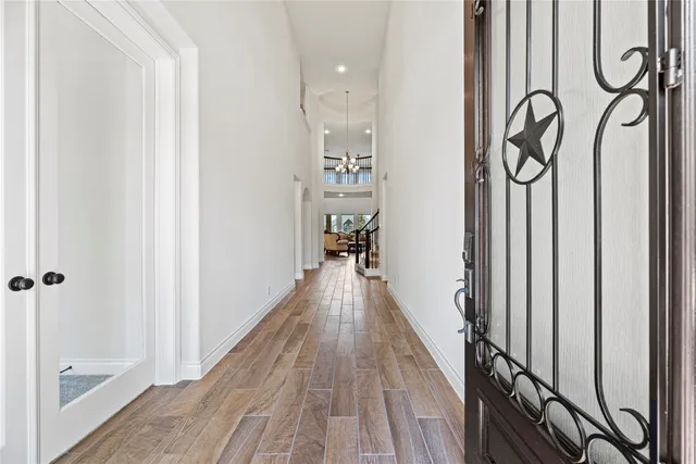 a view of a hallway with wooden floor and staircase