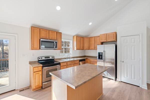 5805 Washer Road Lyles, TN 37098 - Photo 11 of 44 a kitchen with stainless steel appliances granite countertop a stove top oven a sink a refrigerator and white cabinets with wooden floor
