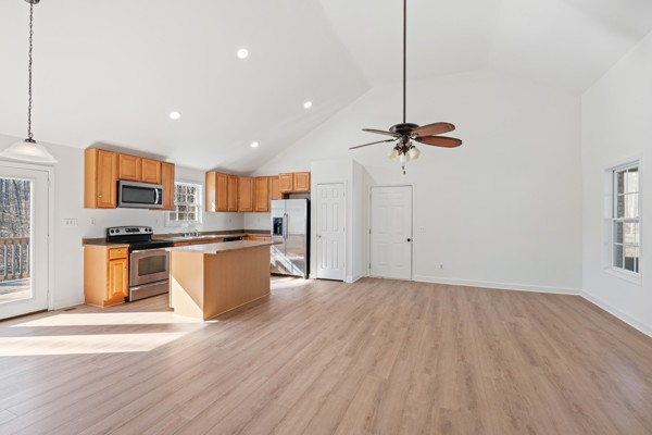 5805 Washer Road Lyles, TN 37098 - Photo 13 of 44 a view of a kitchen with kitchen island a sink wooden floor and stainless steel appliances