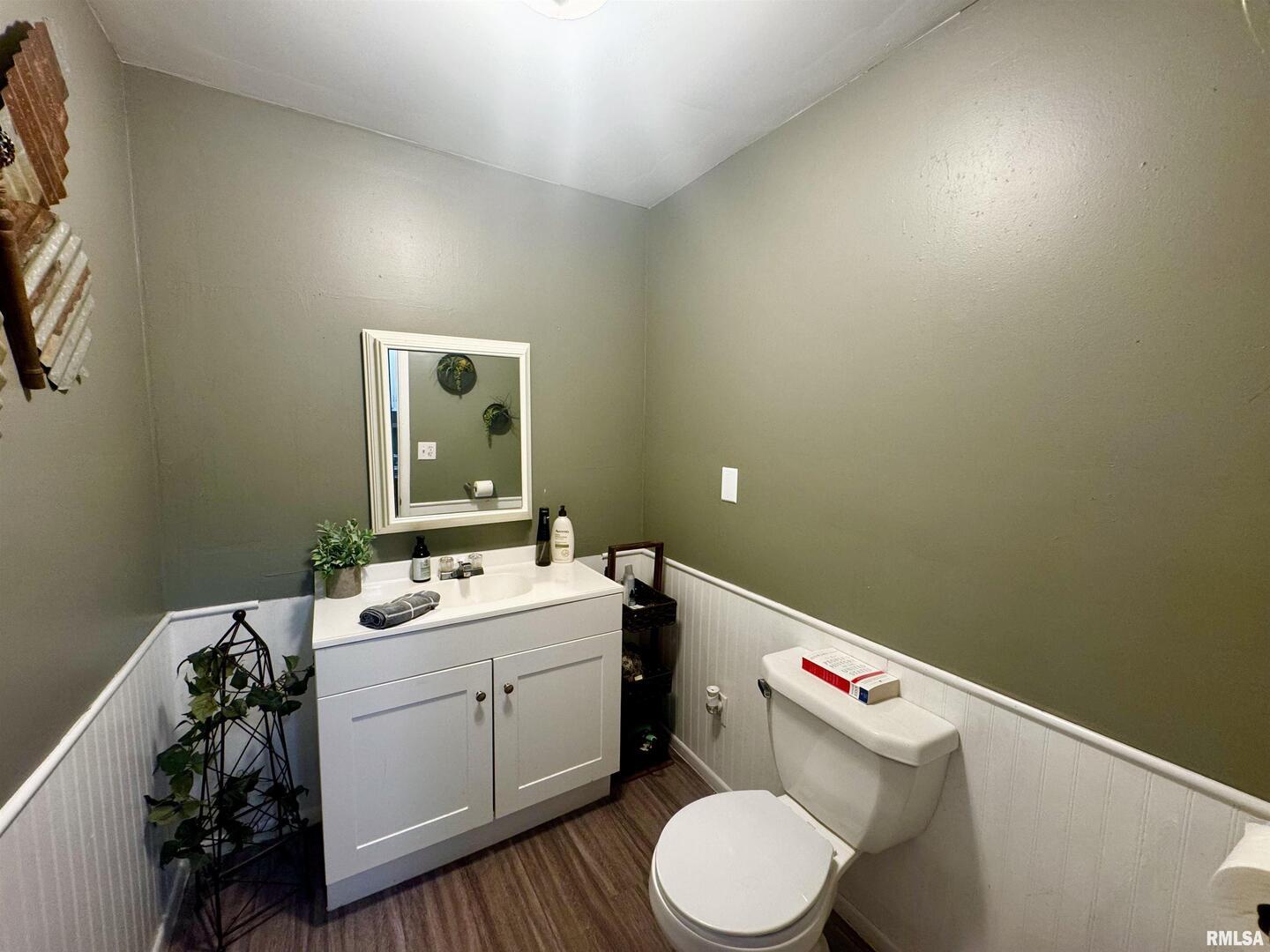 1215 13th Street Viola, IL 61486 - Photo 14 of 35 a bathroom with a sink mirror vanity and toilet