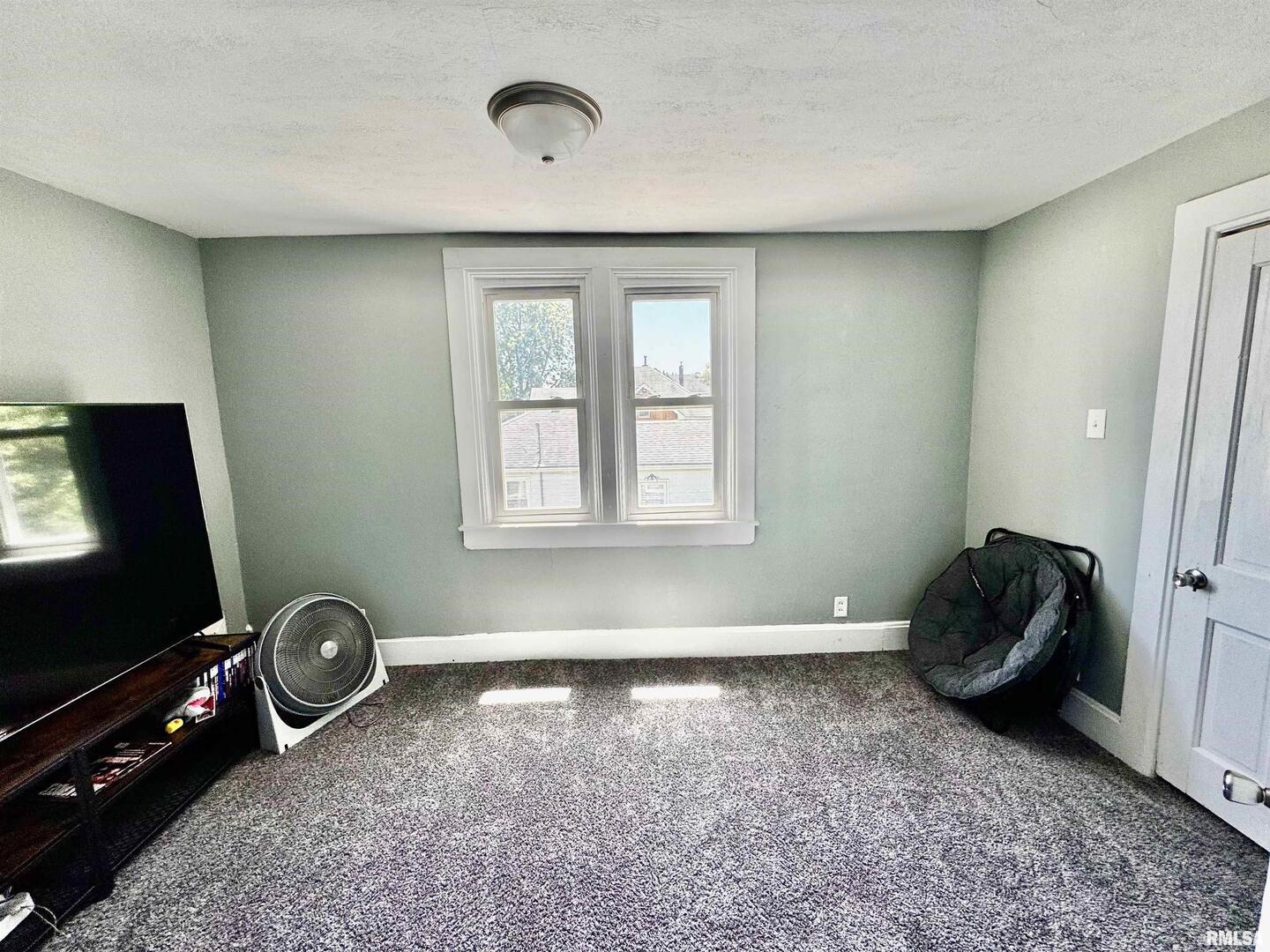 1215 13th Street Viola, IL 61486 - Photo 18 of 35 a living room with furniture and a flat screen tv