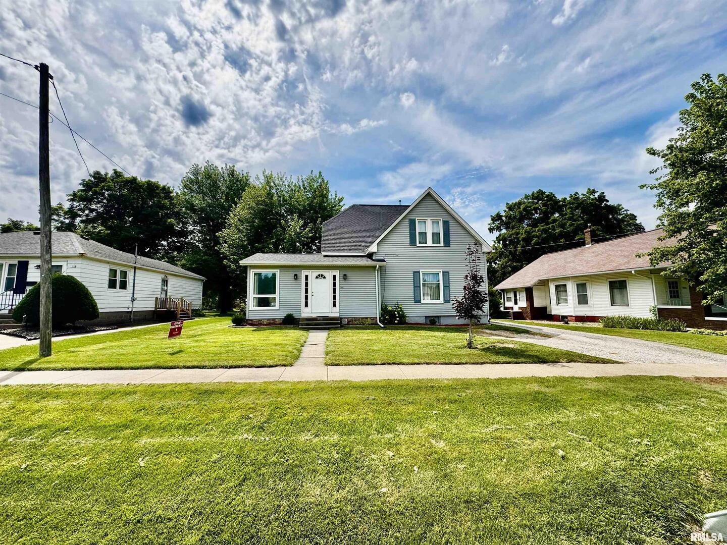 1215 13th Street Viola, IL 61486 - Photo 23 of 35 a front view of a house with a yard and trees