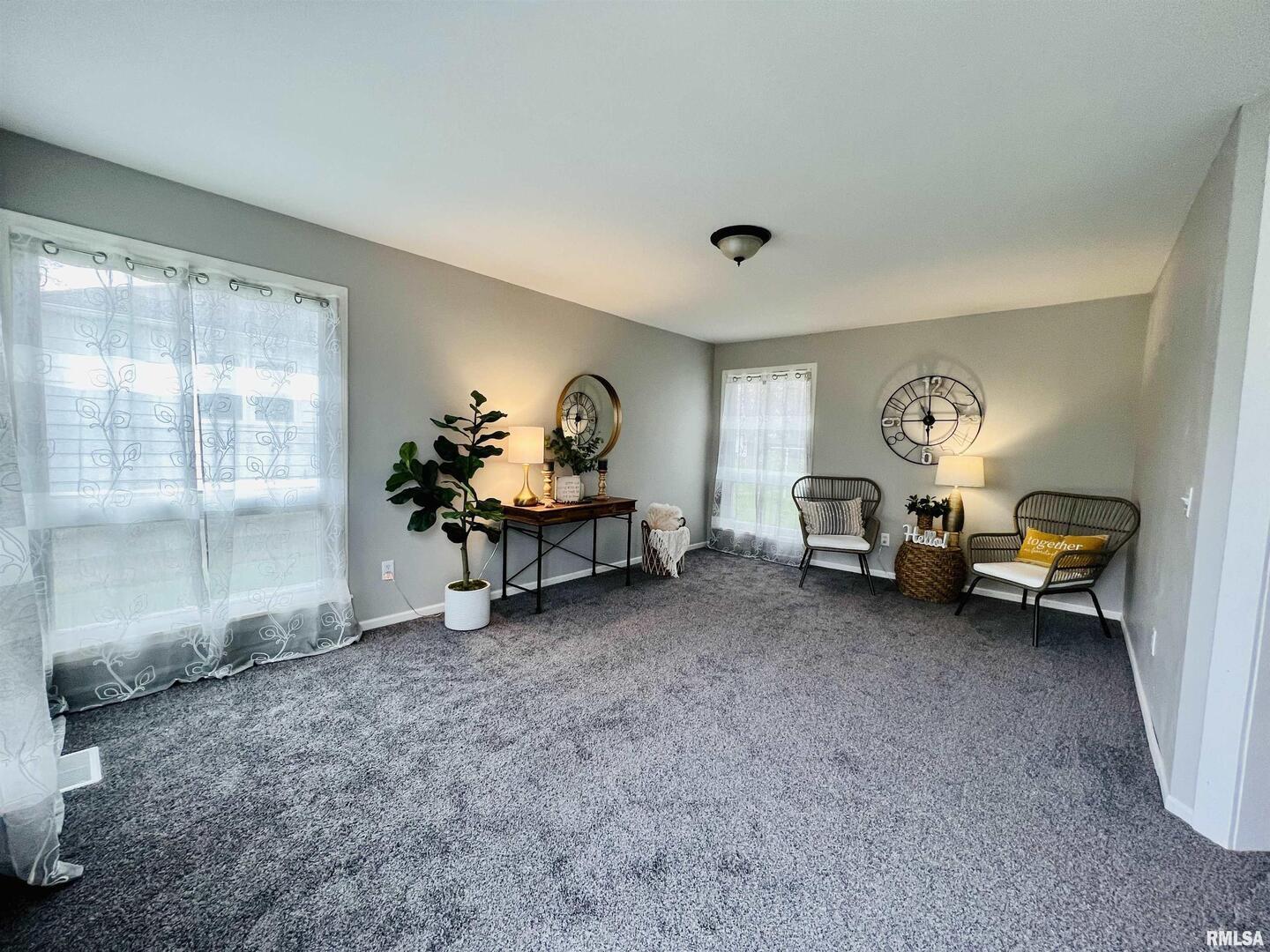 1215 13th Street Viola, IL 61486 - Photo 27 of 35 a living room with furniture a rug and a window