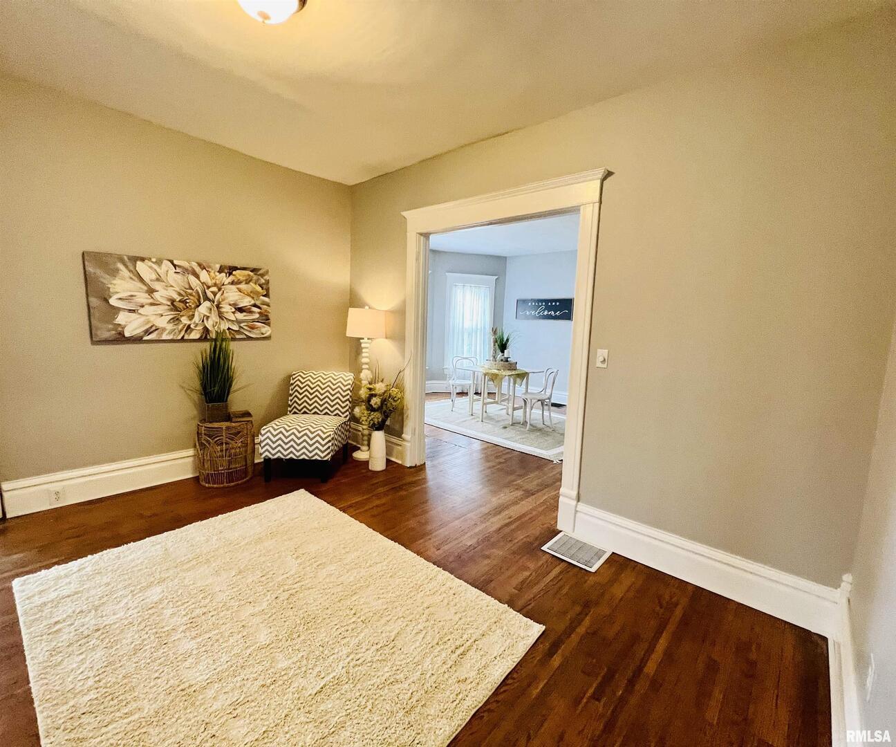 1215 13th Street Viola, IL 61486 - Photo 28 of 35 a bedroom with wooden floor and a bed