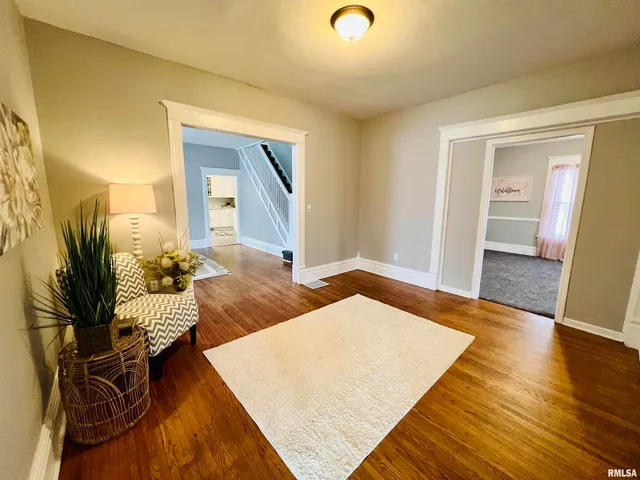 a bedroom with furniture and a wooden floor