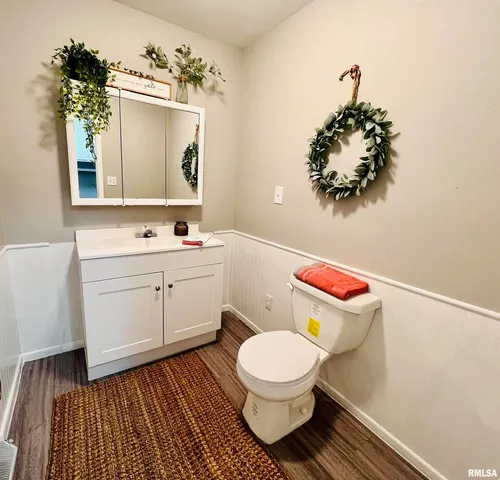 a bathroom with a toilet sink and mirror