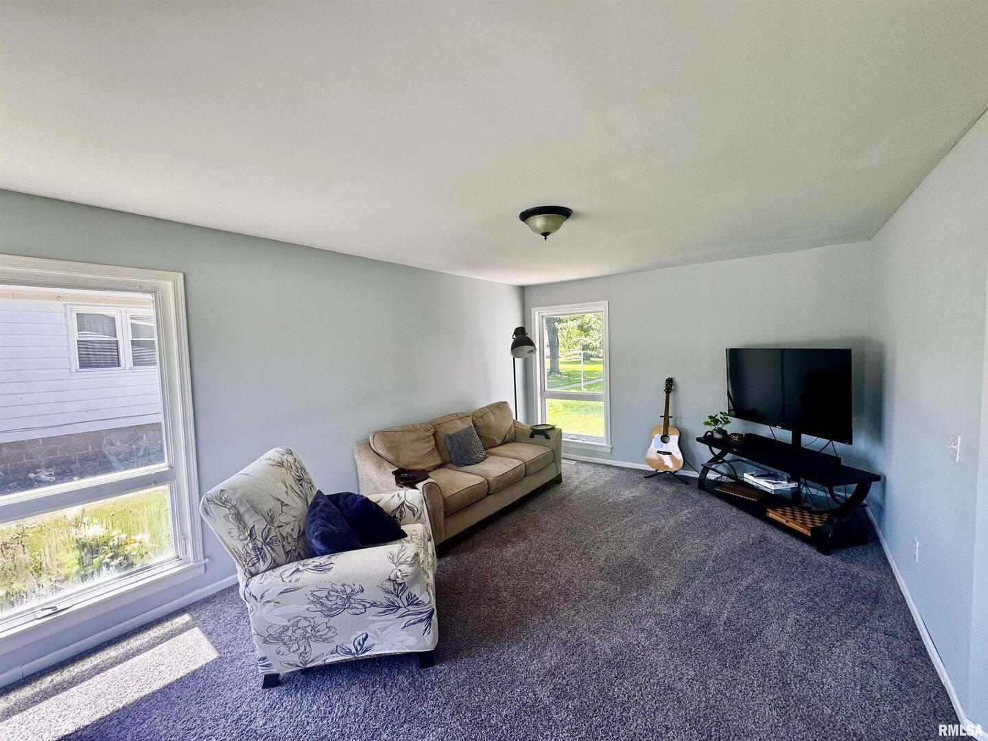 1215 13th Street Viola, IL 61486 - Photo 5 of 35 a living room with furniture and a flat screen tv