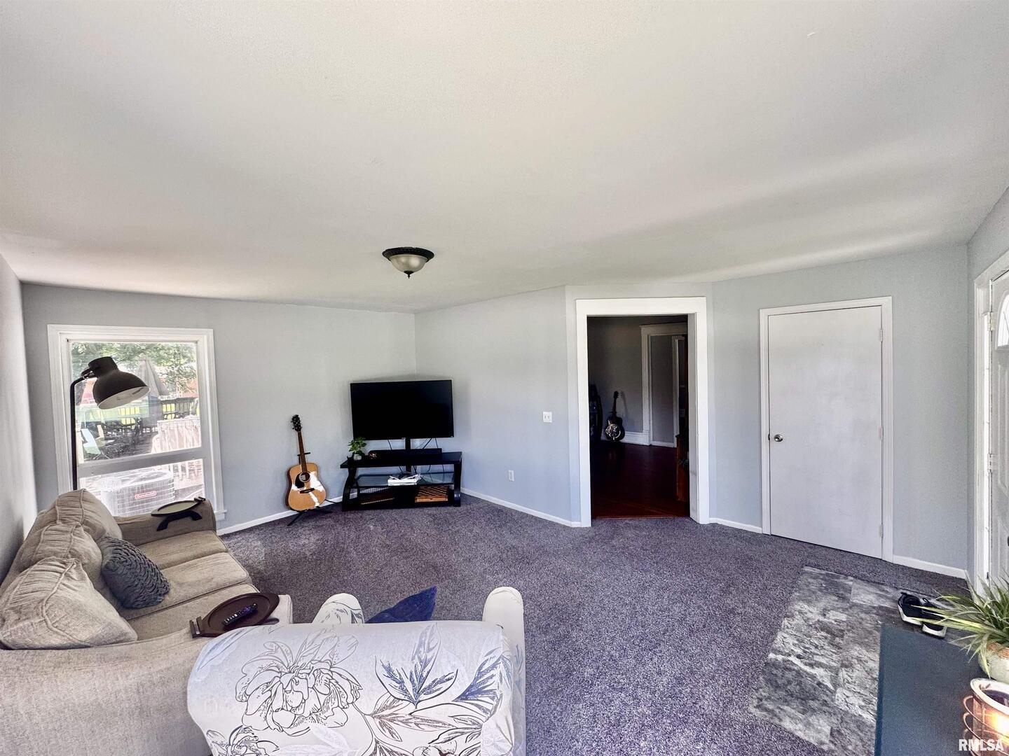 1215 13th Street Viola, IL 61486 - Photo 6 of 35 a living room with furniture and a flat screen tv