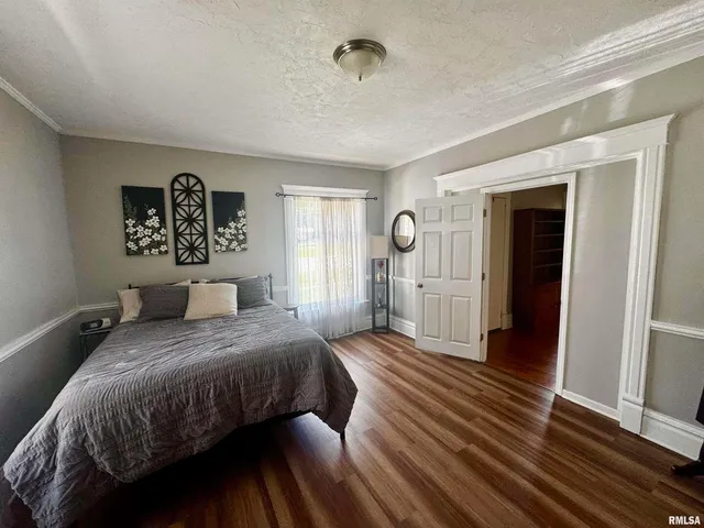 a bedroom with a bed and a large mirror