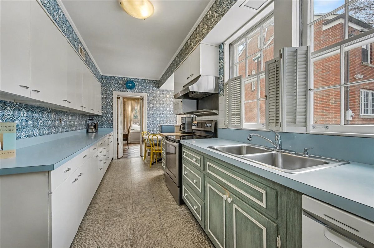900 Sheridan Road Wilmette, IL 60091 - Photo 16 of 31 a kitchen with a sink stove and cabinets