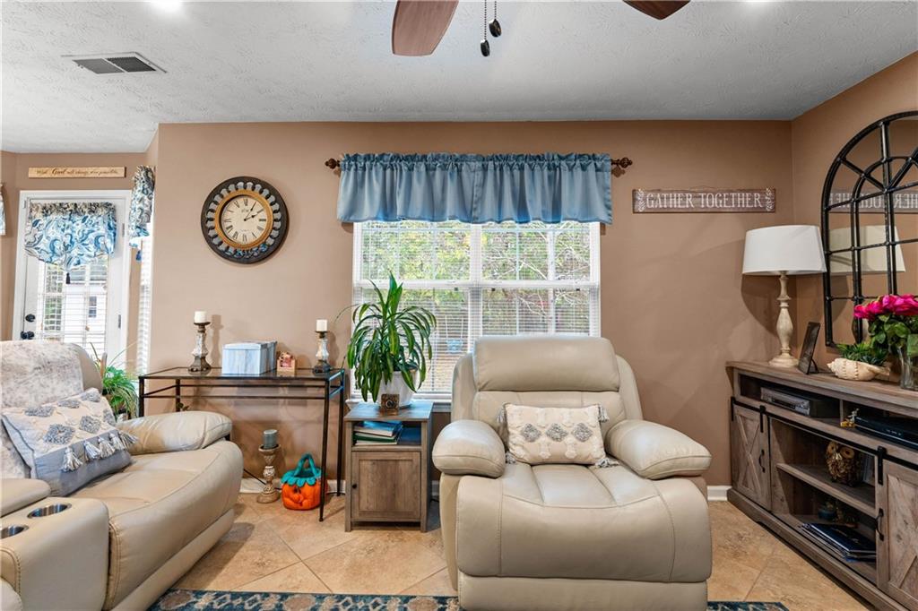 1380 Pebble Beach Lane Hampton, GA 30228 - Photo 14 of 59 a living room with furniture a bed and a large window