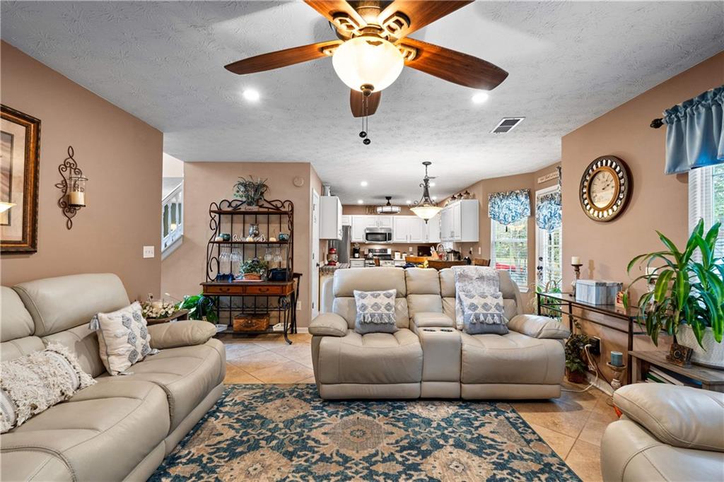 1380 Pebble Beach Lane Hampton, GA 30228 - Photo 15 of 59 a living room with furniture and a ceiling fan