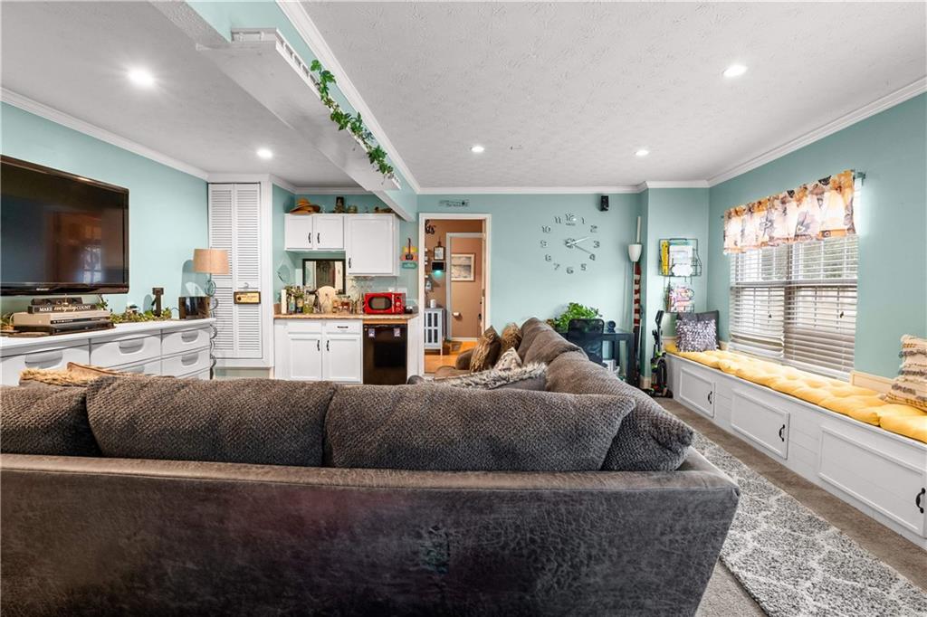 1380 Pebble Beach Lane Hampton, GA 30228 - Photo 24 of 59 a living room with furniture and a flat screen tv