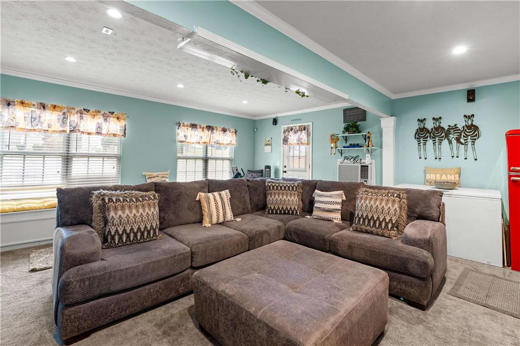 1380 Pebble Beach Lane Hampton, GA 30228 - Photo 25 of 59 a living room with furniture and a large window