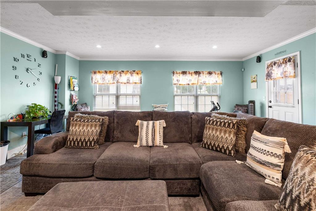 1380 Pebble Beach Lane Hampton, GA 30228 - Photo 28 of 59 a living room with furniture and a large window