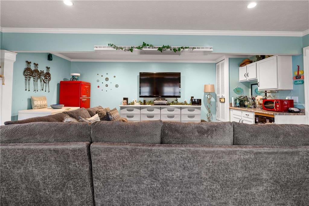 1380 Pebble Beach Lane Hampton, GA 30228 - Photo 29 of 59 a living room with furniture and a flat screen tv