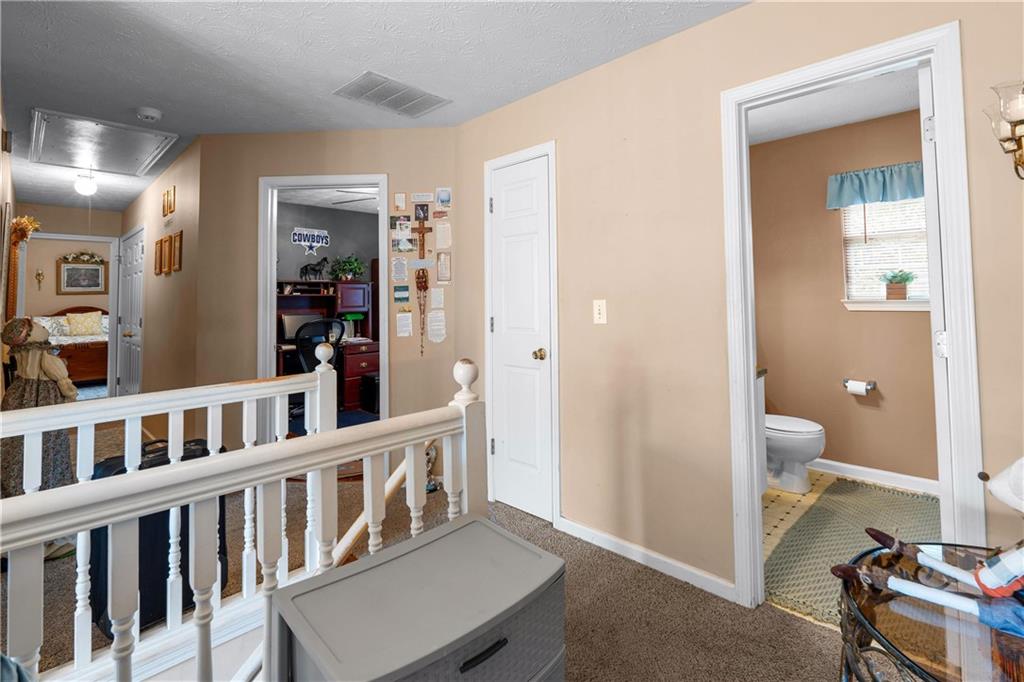 1380 Pebble Beach Lane Hampton, GA 30228 - Photo 31 of 59 a view of a hallway with a livingroom and a bathroom