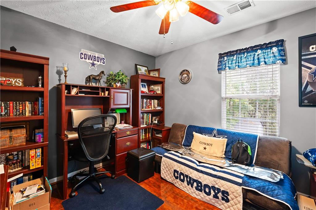 1380 Pebble Beach Lane Hampton, GA 30228 - Photo 38 of 59 a work room with furniture and a bookshelf