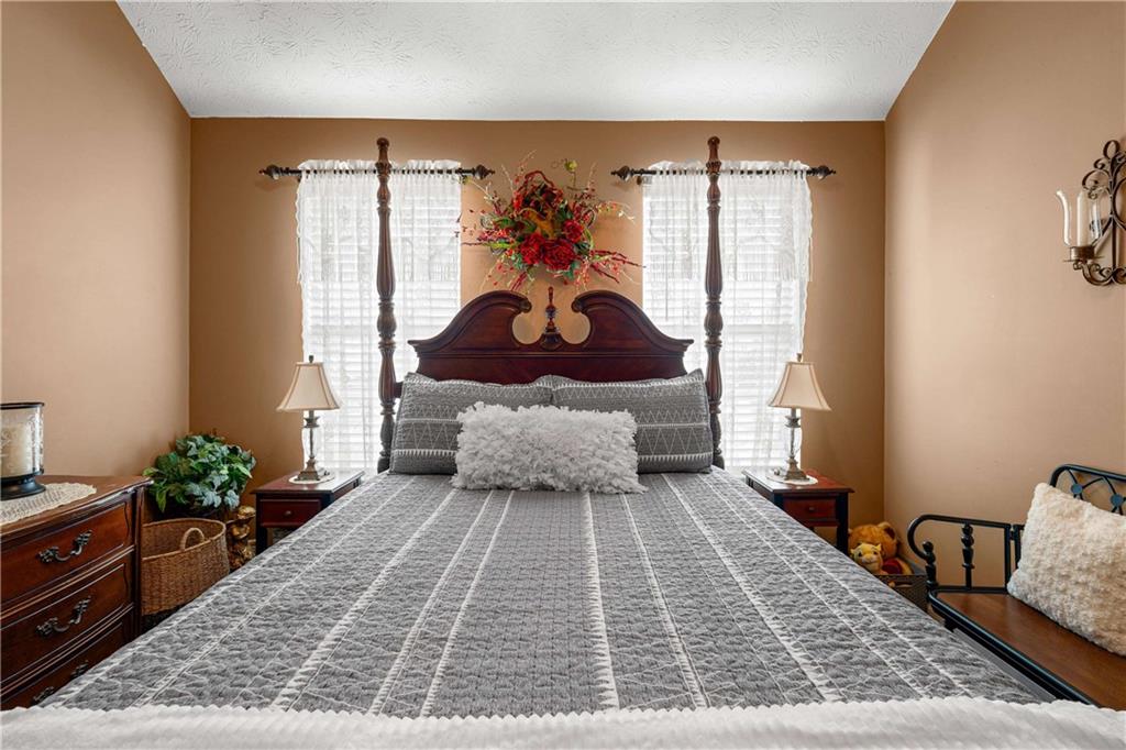 1380 Pebble Beach Lane Hampton, GA 30228 - Photo 41 of 59 a bed sitting in a bedroom next to a window