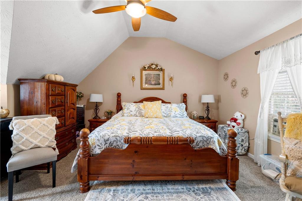 1380 Pebble Beach Lane Hampton, GA 30228 - Photo 46 of 59 a bedroom with a bed and a chandelier