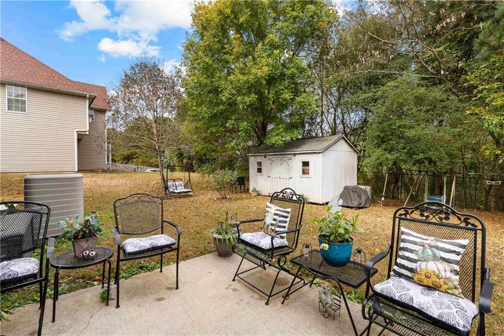 1380 Pebble Beach Lane Hampton, GA 30228 - Photo 52 of 59 a backyard of a house with barbeque oven table and chairs