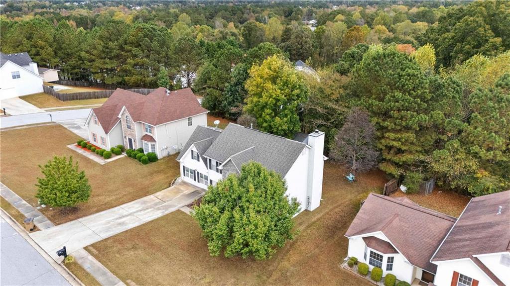 1380 Pebble Beach Lane Hampton, GA 30228 - Photo 56 of 59 an aerial view of a house with a yard and trees
