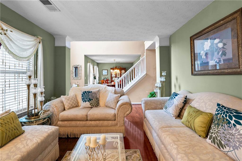 1380 Pebble Beach Lane Hampton, GA 30228 - Photo 7 of 59 a living room with furniture and a large window