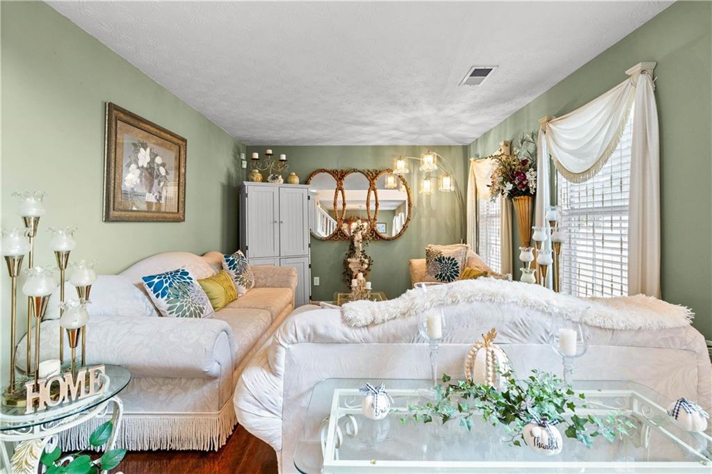 1380 Pebble Beach Lane Hampton, GA 30228 - Photo 8 of 59 a living room with furniture and a large window