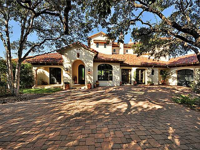 a front view of a building and trees