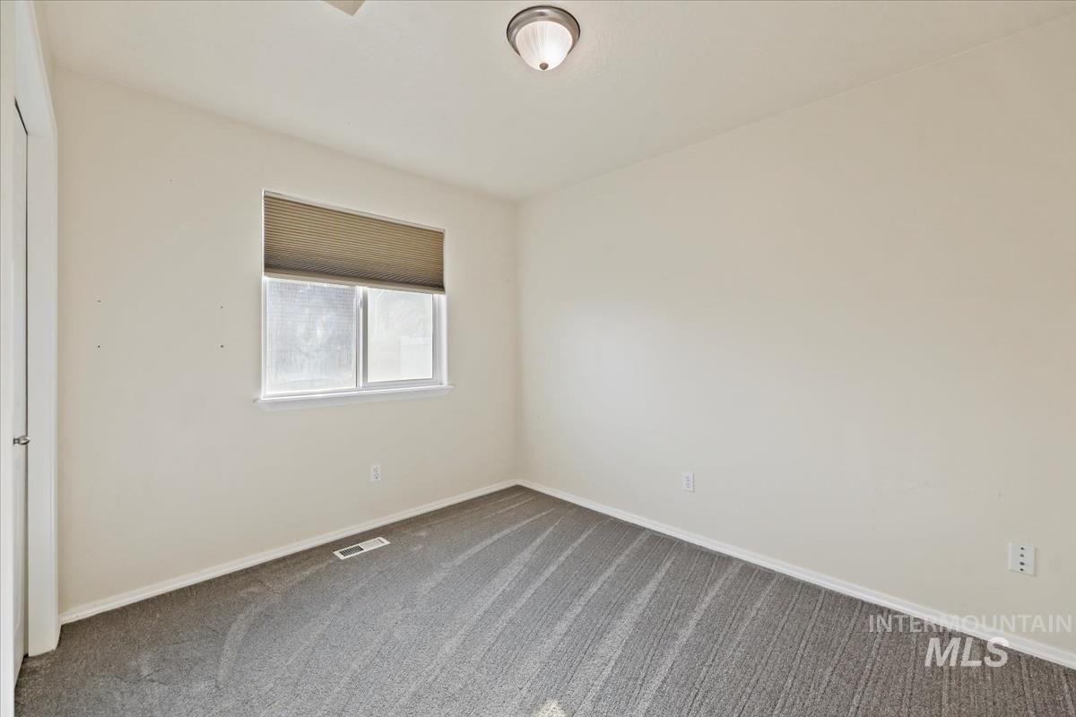612 Goshawk Avenue Middleton, ID 83644 - Photo 21 of 36 Empty room with carpet floors and baseboards