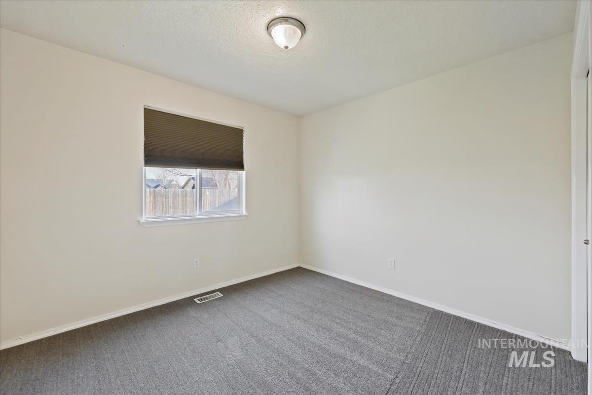 612 Goshawk Avenue Middleton, ID 83644 - Photo 24 of 36 Carpeted spare room featuring baseboards and a textured ceiling
