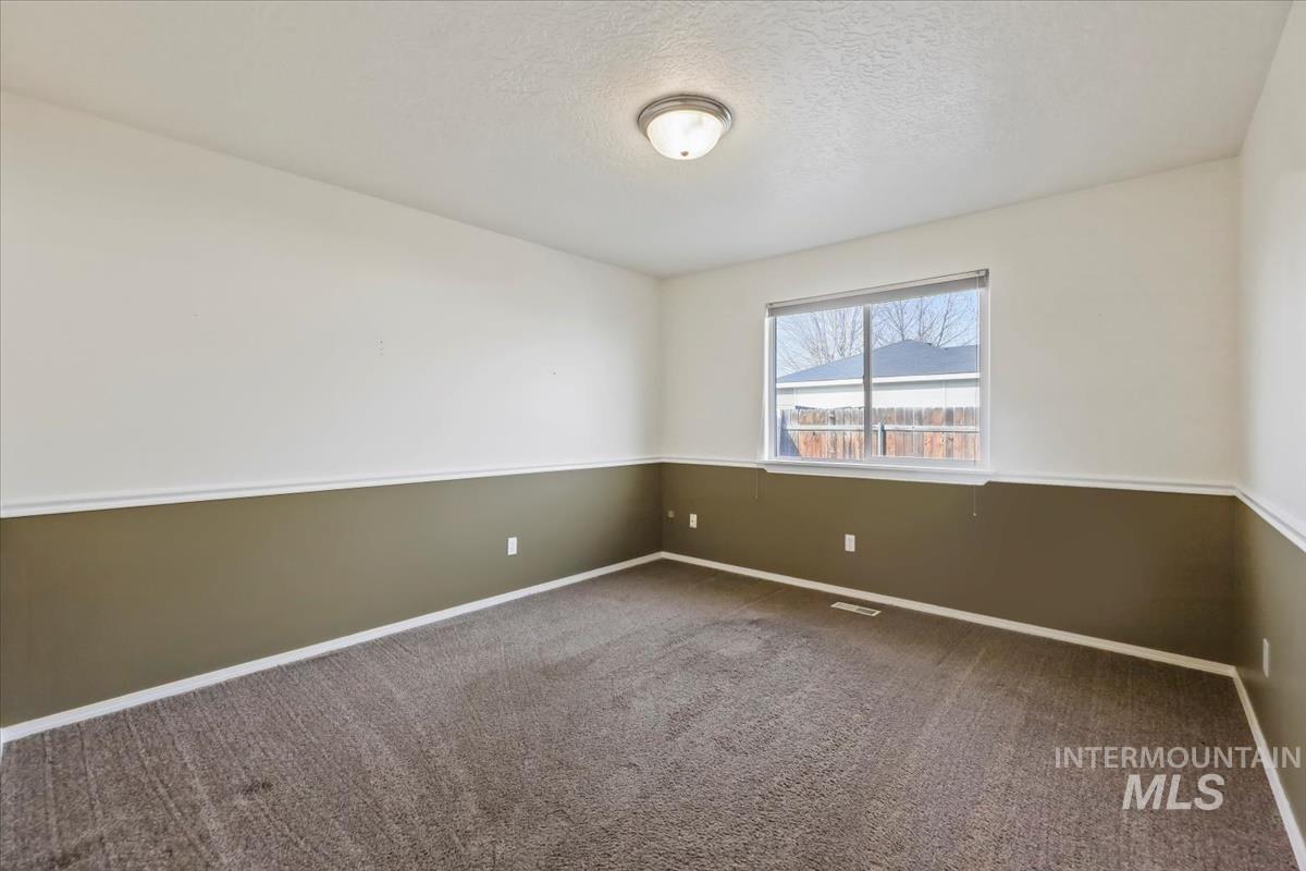 612 Goshawk Avenue Middleton, ID 83644 - Photo 26 of 36 Carpeted empty room with a textured ceiling and baseboards