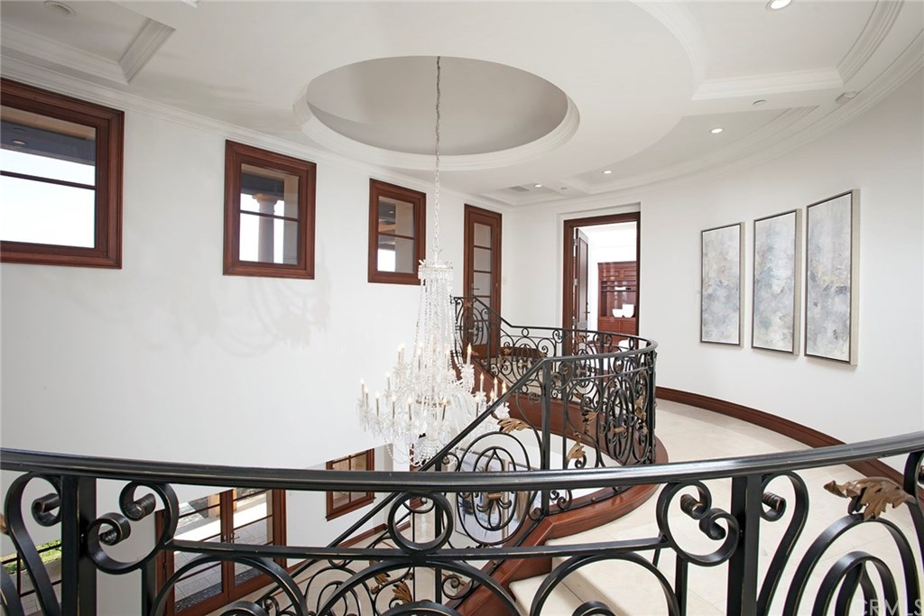 32 Boulder View Irvine, CA 92603 - Photo 25 of 73 a view of a hallway with a bike and wooden floor