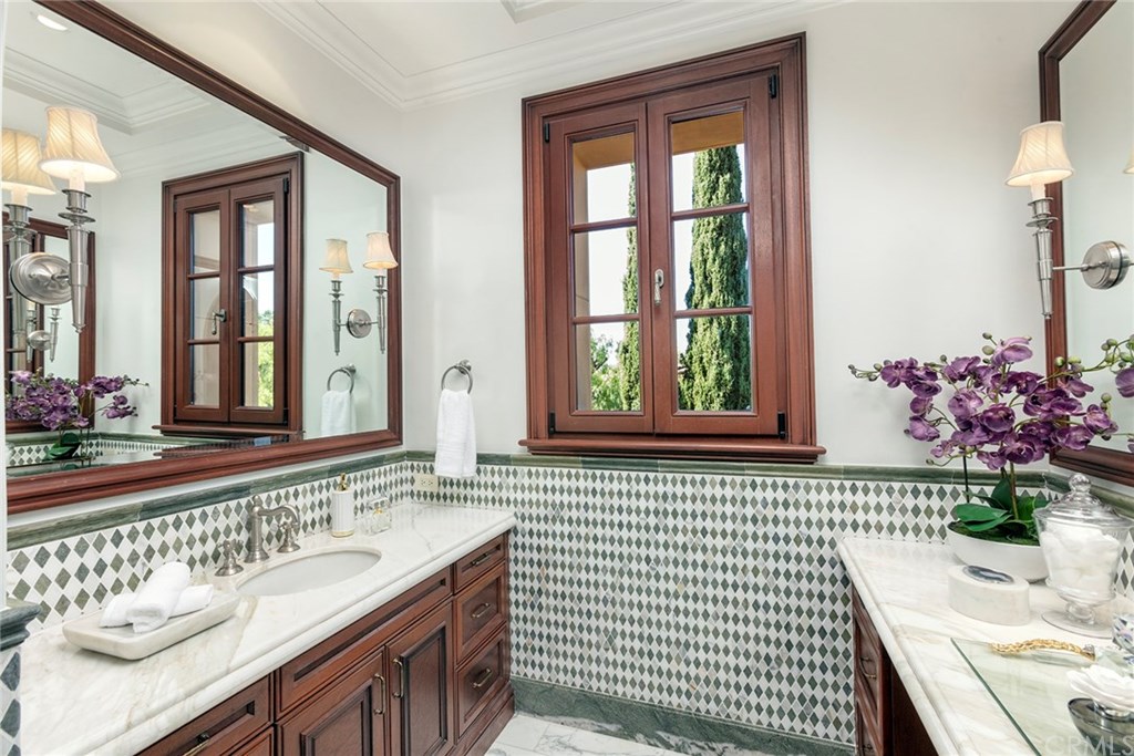 32 Boulder View Irvine, CA 92603 - Photo 33 of 73 a bathroom with a sink a mirror and a window