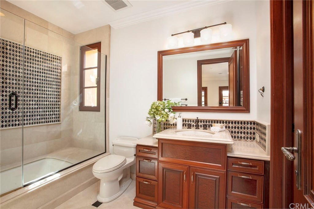 32 Boulder View Irvine, CA 92603 - Photo 43 of 73 a bathroom with a sink toilet a mirror and shower