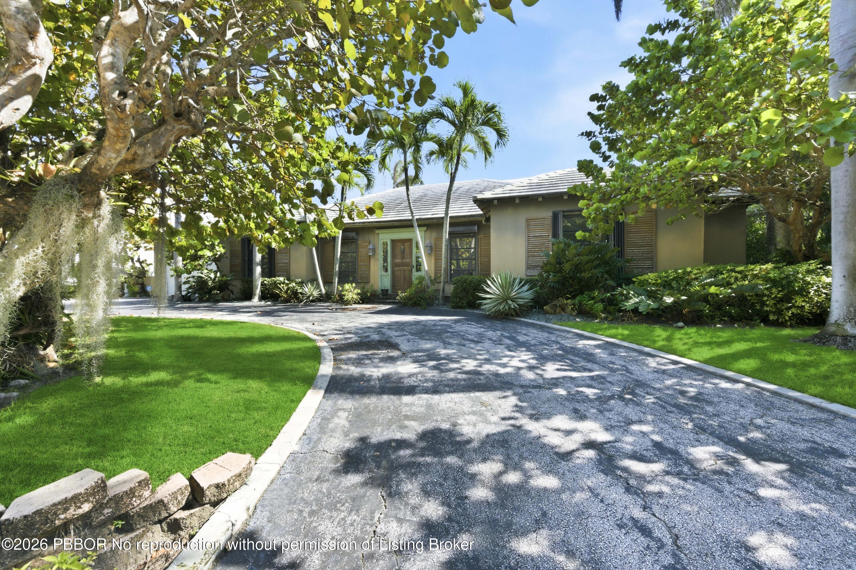 112 Algoma Road Palm Beach, FL 33480 - Photo 1 of 4 a front view of a house with a yard