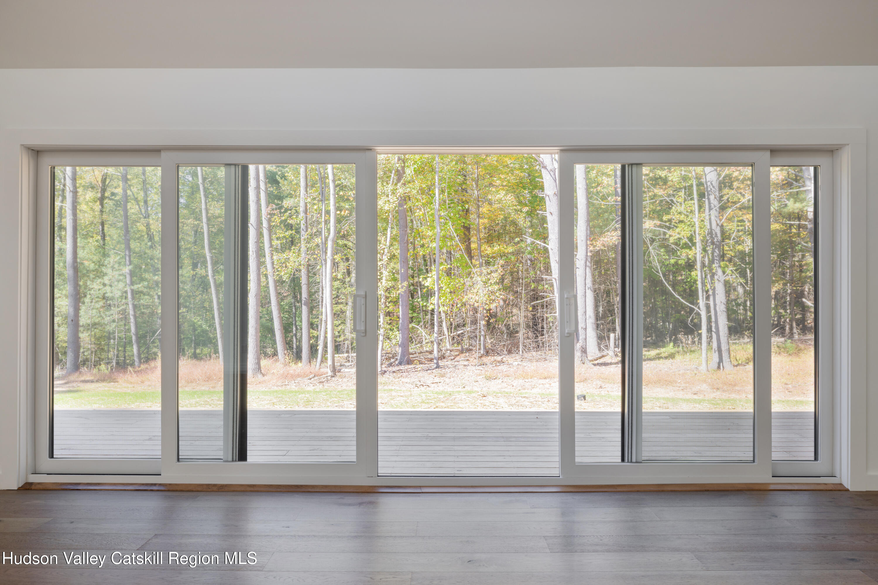 246 South Road Ruby, NY 12475 - Photo 23 of 35 a view of empty room with wooden floor and floor to ceiling window