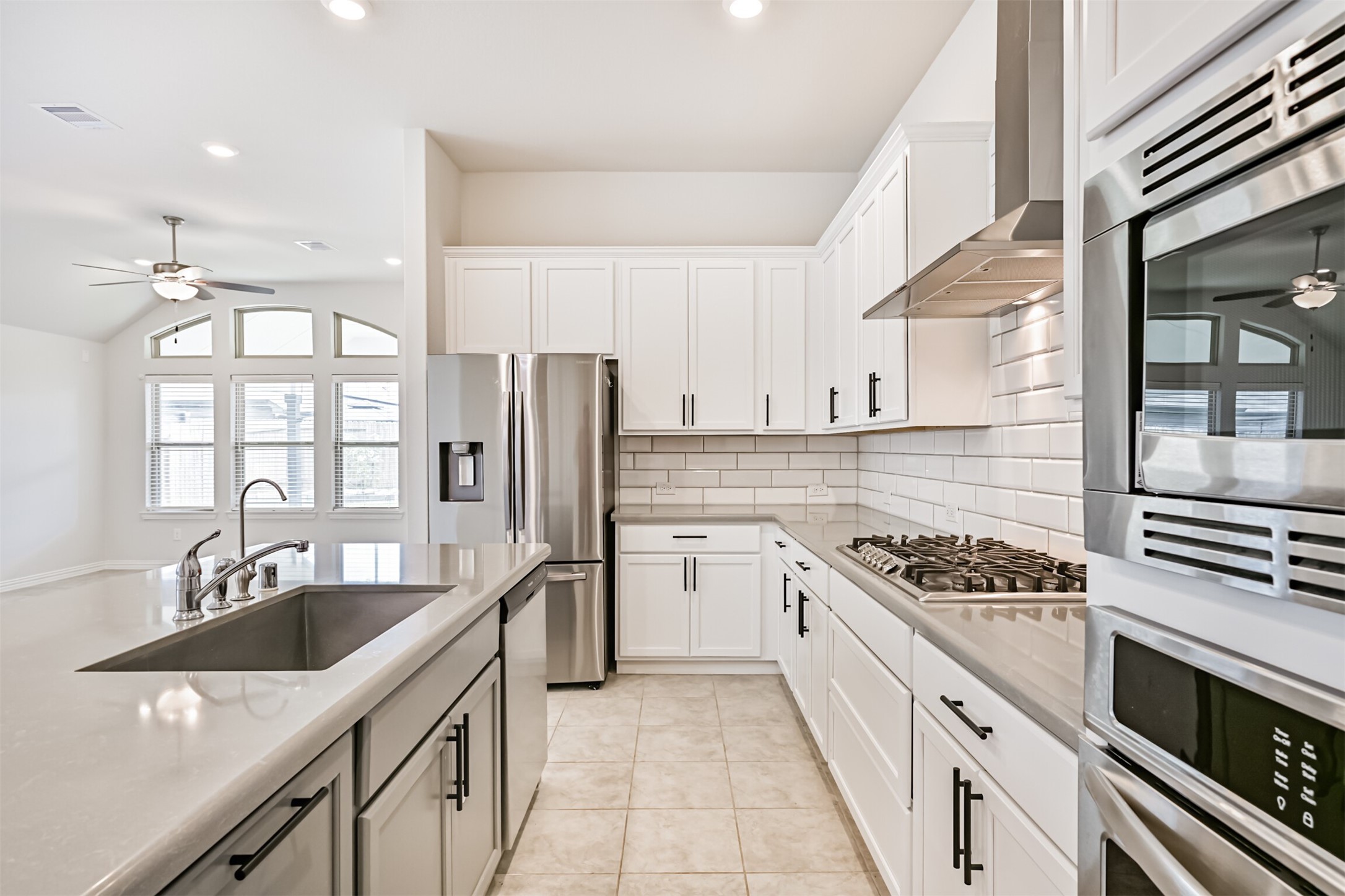 7019 Terra Drive Manvel, TX 77578 - Photo 22 of 41 a kitchen with a sink stove top oven and refrigerator