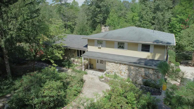 a front view of a house with yard and green space