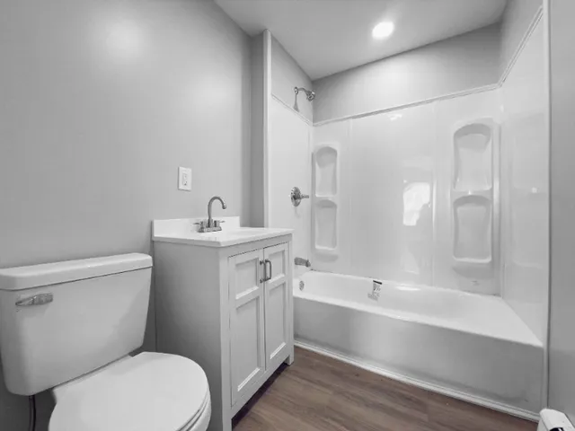 a bathroom with a sink mirror vanity and toilet