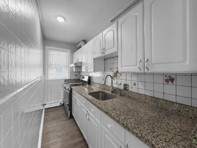 a kitchen with sink cabinets and window
